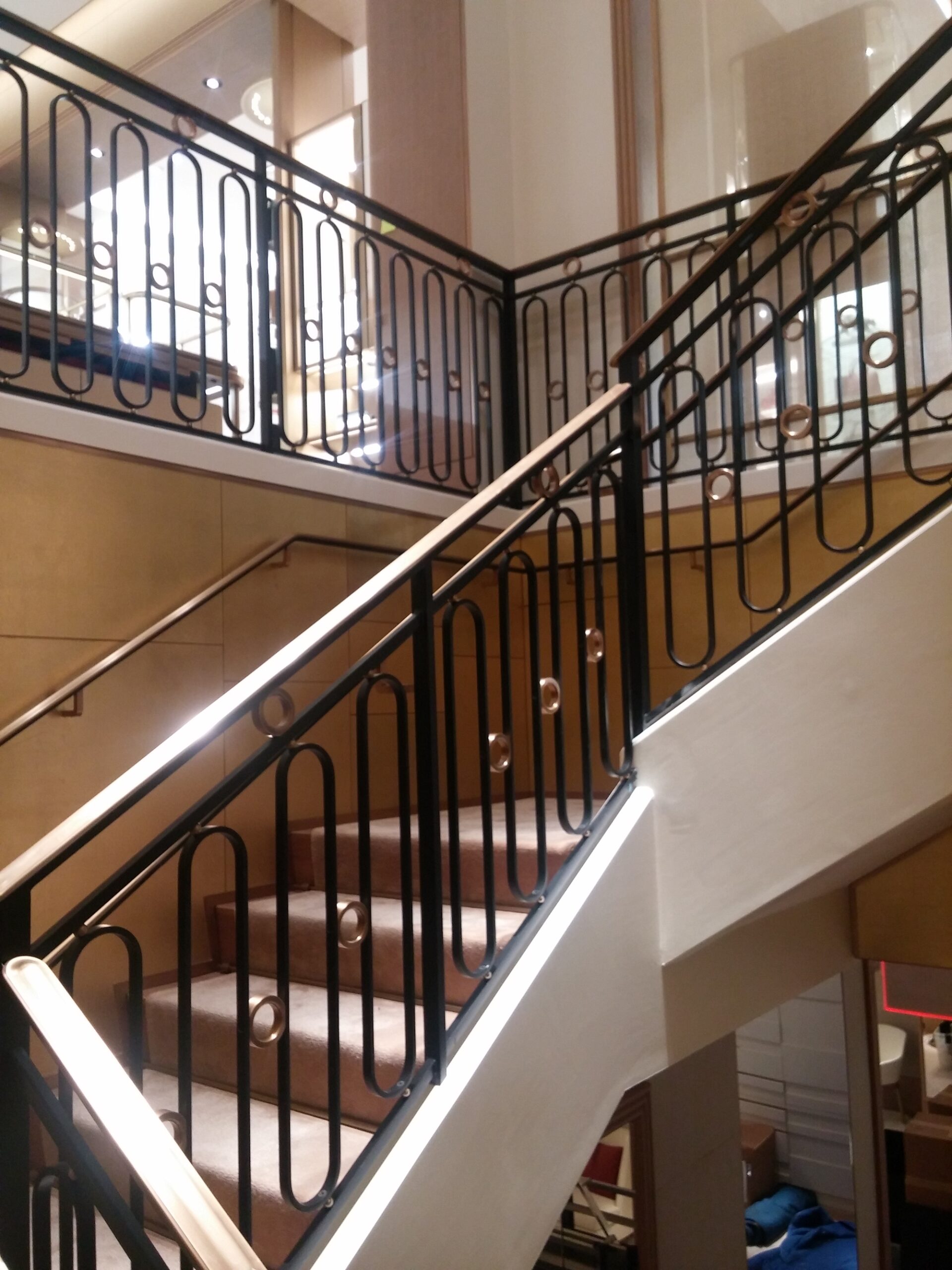 custom iron stair railing with gold accents