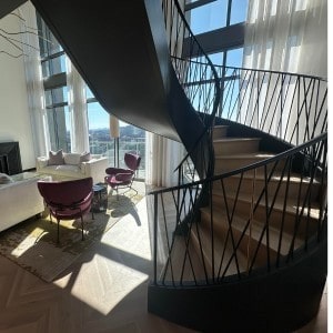 Transitional Floating Curved Staircase with Iron Balusters