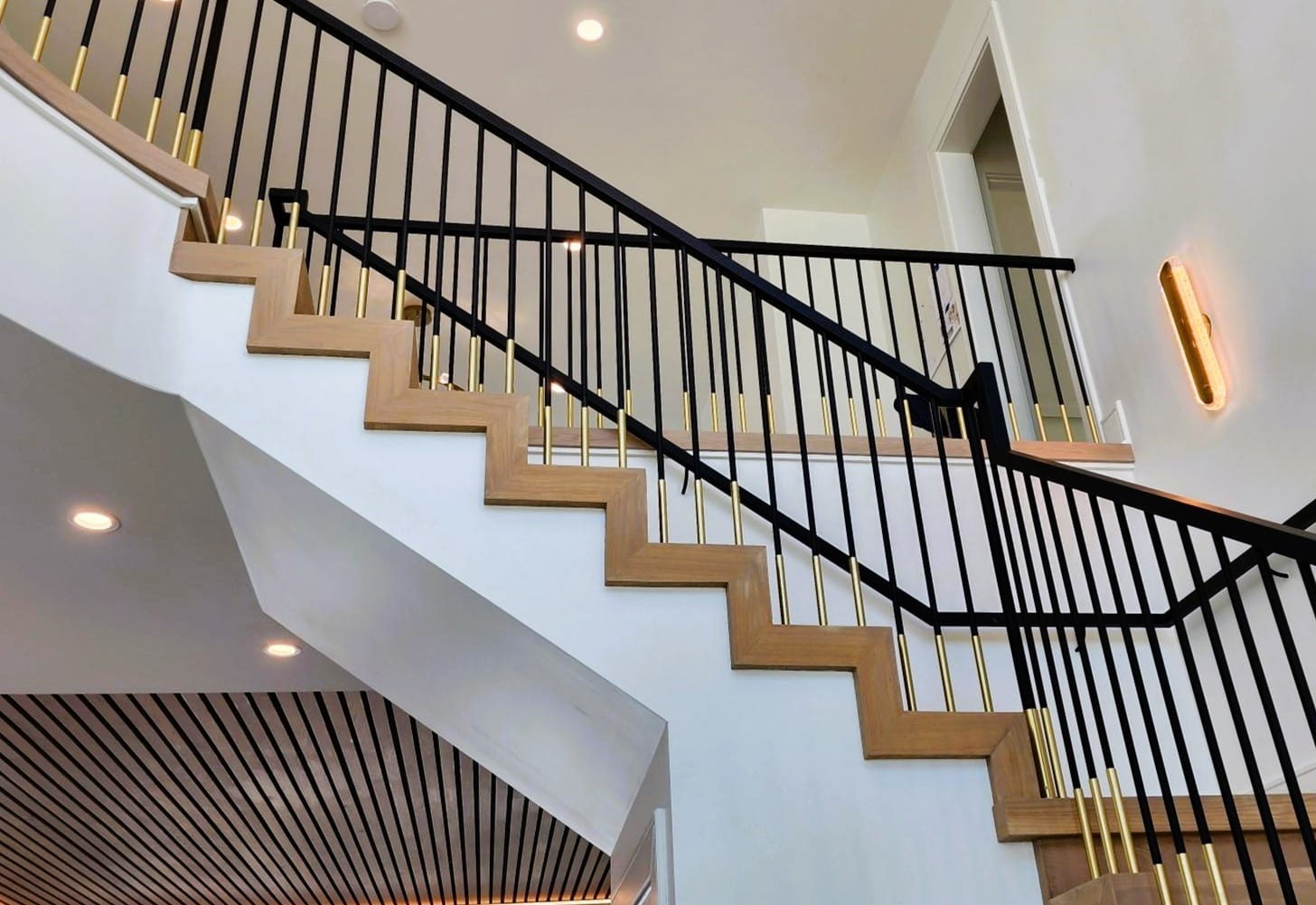 Modern Staircase Ideas: (closed risers staircase in white oak with custom tread and custom-welded rail system in black metal with brass trim)