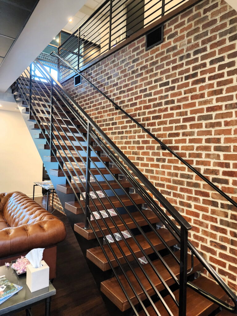 Conway, SC open riser stairs dual sawcut stringers with 4 white oak treads and custom welded modern black metal railing
